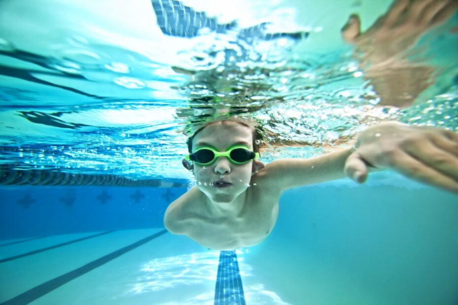 underwater shot of boy swimming laps in pool