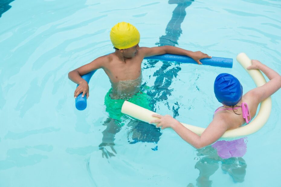 two-kids-swimming-in-pool-WJHDN5Y_1200x800